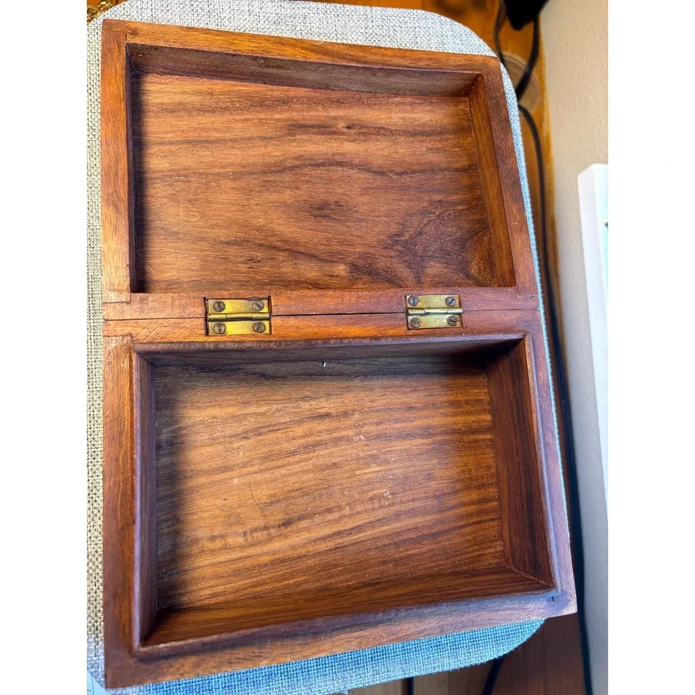 Handmade wooden jewelry box with a brass inlay and hand-carved floral design